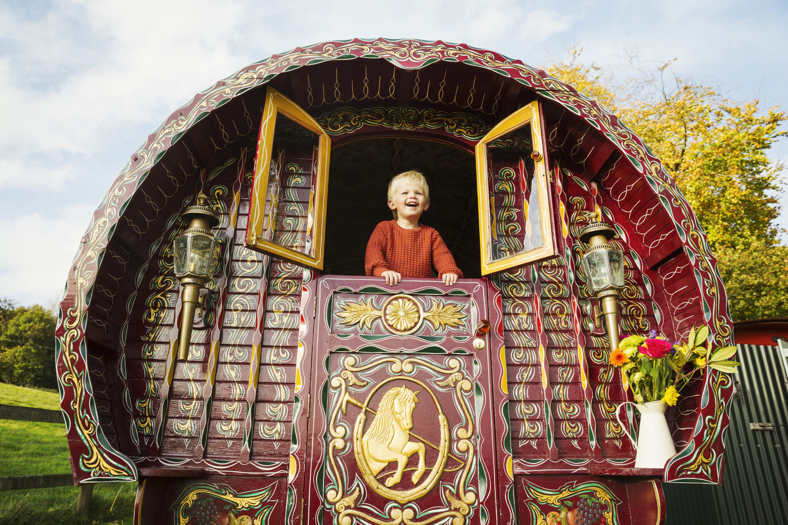 a-boy-leaning-out-of-the-open-shutters-at-the-rear-2026-01-09-08-42-13-utc